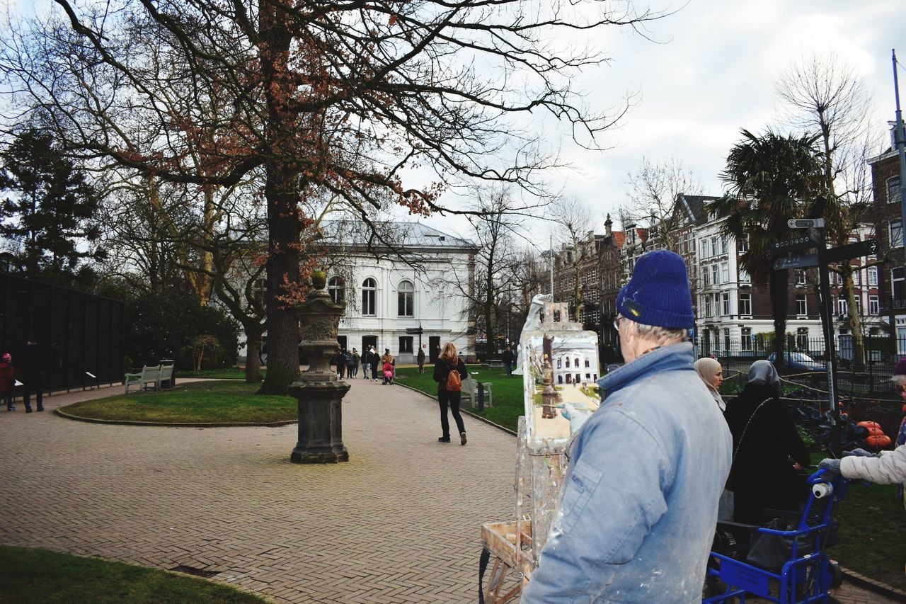 architecture, real people, tree, building exterior, built structure, city, men, rear view, group of people, lifestyles, people, plant, nature, building, day, sky, incidental people, adult, bare tree, leisure activity, outdoors, warm clothing