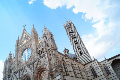 Low angle view of temple against cloudy sky