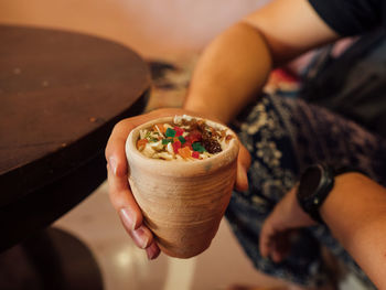 High angle view of hand holding marijuana lassi 