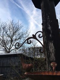 Low angle view of bare tree against sky