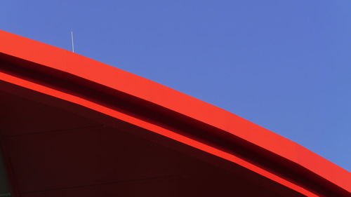 Cropped image of red building against clear sky