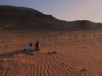 Man on sand at beach against sky