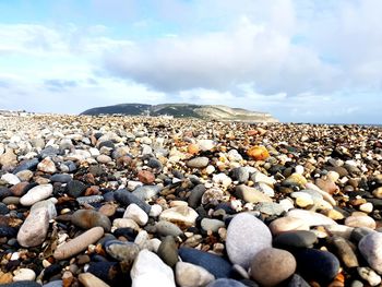 Rocks on beach against sky