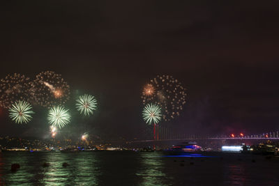 Low angle view of firework display at night