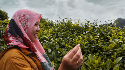 Women enjoying nature share their own photo moments among the lush tea gardens