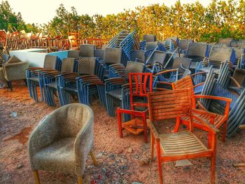 Empty chairs and table against trees