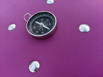 Close-up of clock against pink background