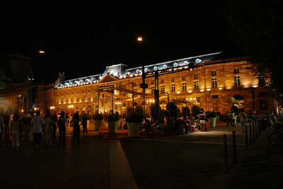 People in illuminated city at night