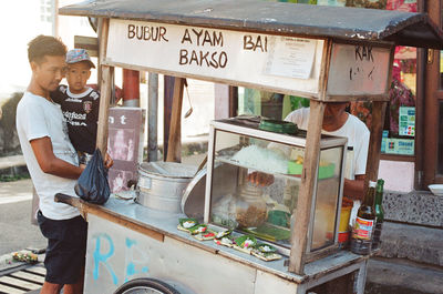 Men standing at market stall