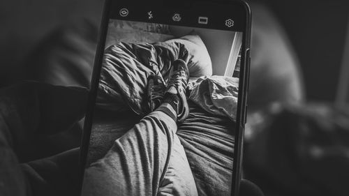 High angle view of man sleeping on bed at home