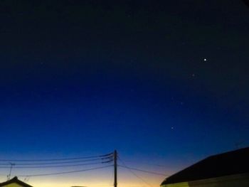 Low angle view of cables against sky at night