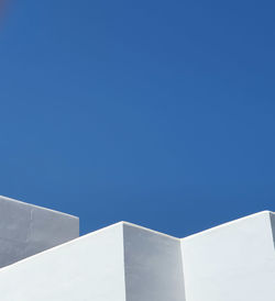 Low angle view of building against clear blue sky