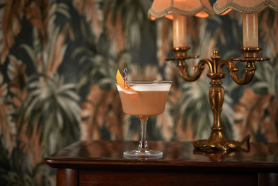 Orange sour cocktail in vintage room