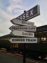 Low angle view of road sign against sky