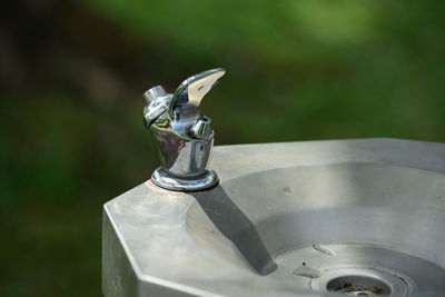 Close-up of faucet in container