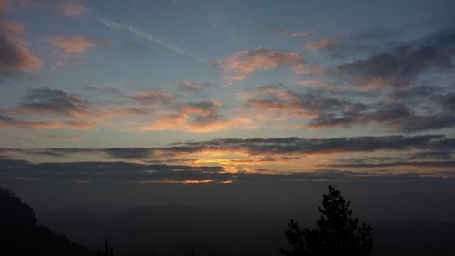 Scenic view of mountains against sky at sunset