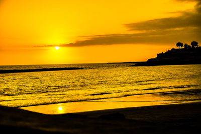 Scenic view of sea against orange sky