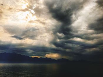 Scenic view of lake against cloudy sky