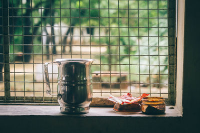 Close-up of jug on window sill