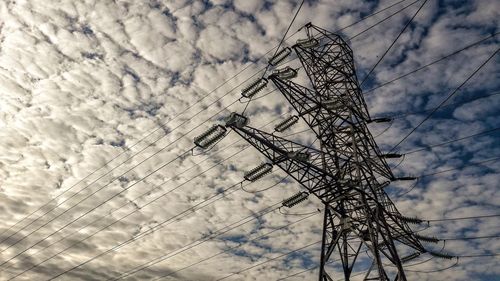 Low angle view of electricity pylon against sky