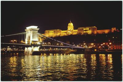 Illuminated suspension bridge at night