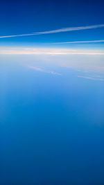 Aerial view of sea against blue sky