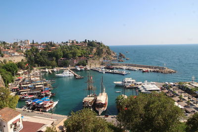 High angle view of boats moored in sea against clear sky