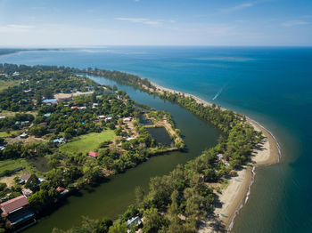 High angle view of trees and sea against sky