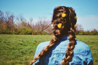 Rear view of woman standing in field