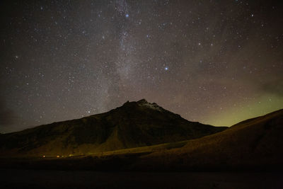 Scenic view of mountains against sky at night