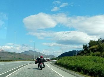 Rear view of man walking on country road