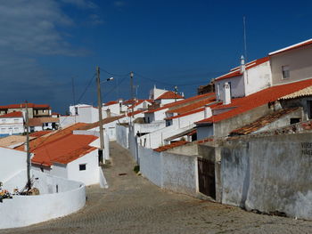 White houses in town against blue sky 