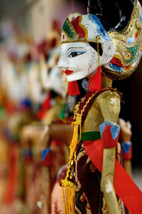 Close-up of multi colored wooden puppets at store