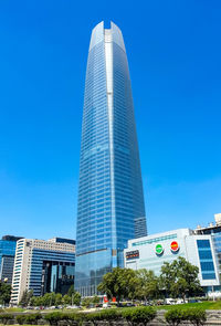 Low angle view of modern buildings against blue sky