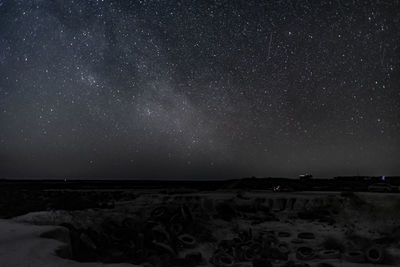 Scenic view of land against sky at night