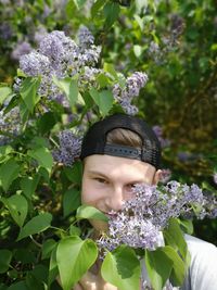 Portrait of man against purple flowering plants