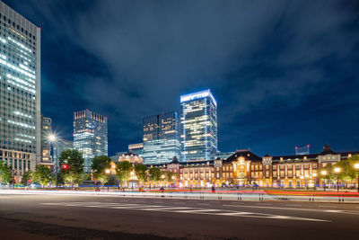 Illuminated buildings against sky at night