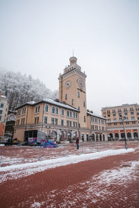 View of snow covered buildings against sky