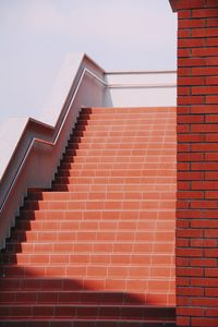 Stairs against brick wall