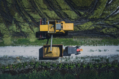 Directly above view of combine harvester on field