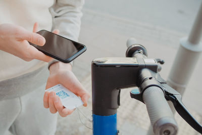 Midsection of man using mobile phone