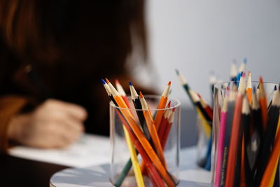 Close-up of colored pencils in desk organizers