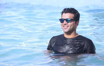 Portrait of smiling young man in sea