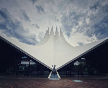 Modern building against cloudy sky