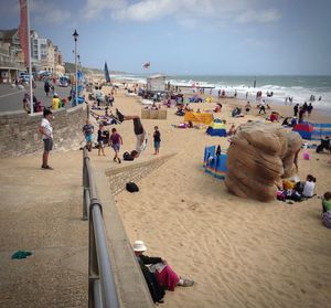 People at beach against sky