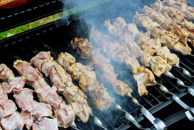 High angle view of meat on barbecue grill