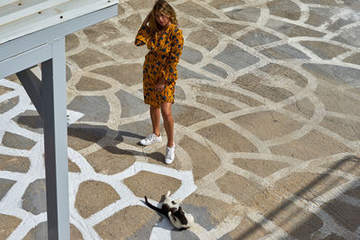 High angle view of woman standing on tiled floor