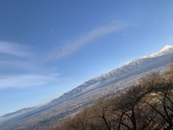 Scenic view of snowcapped mountains against blue sky