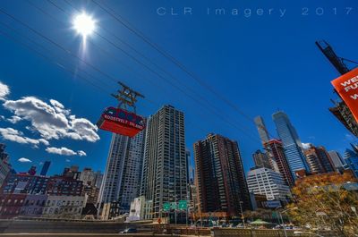 Low angle view of skyscrapers against blue sky