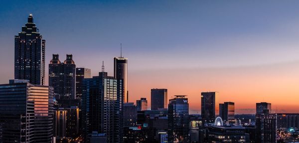 Illuminated cityscape against sky